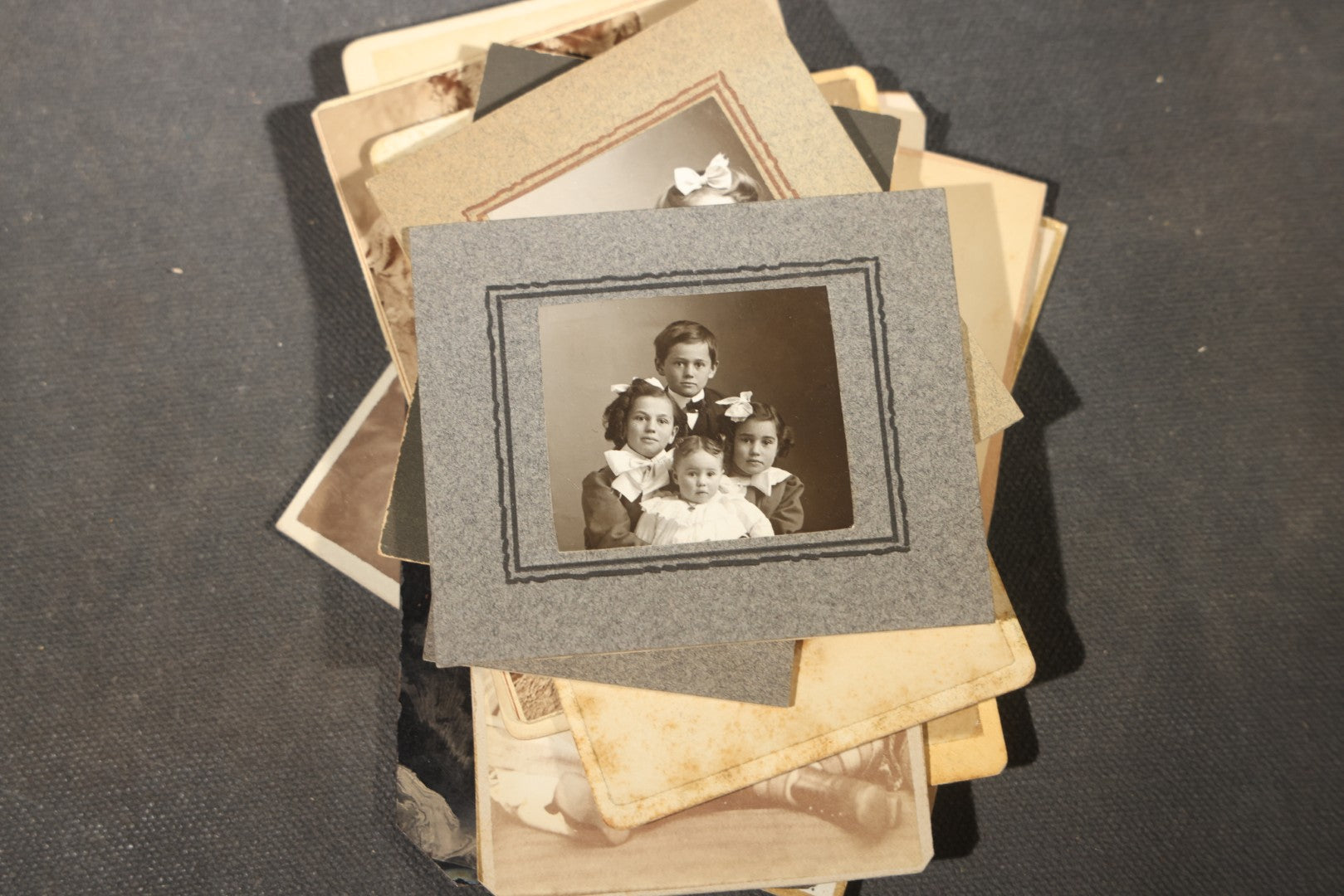 Grouping of 40+ Antique Photographs Including Carte De Visite C.D.V. Portraits, Tintype Photographs, and Board-Mounted Photographs, including young children, women with curled bangs, and more