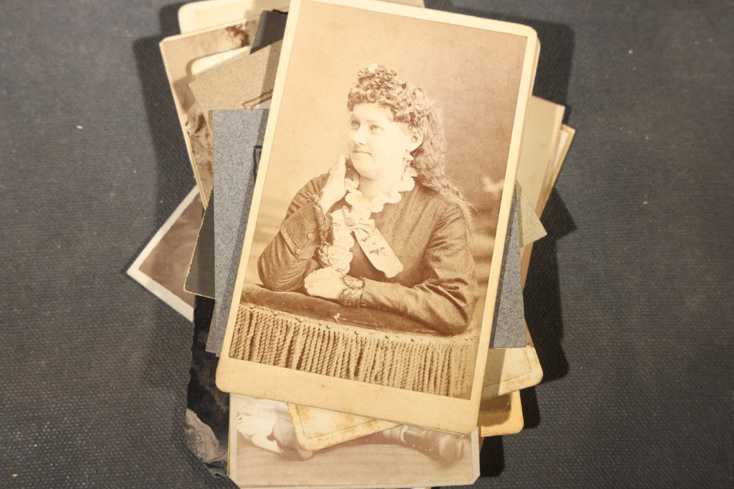 Grouping of 40+ Antique Photographs Including Carte De Visite C.D.V. Portraits, Tintype Photographs, and Board-Mounted Photographs, including young children, women with curled bangs, and more