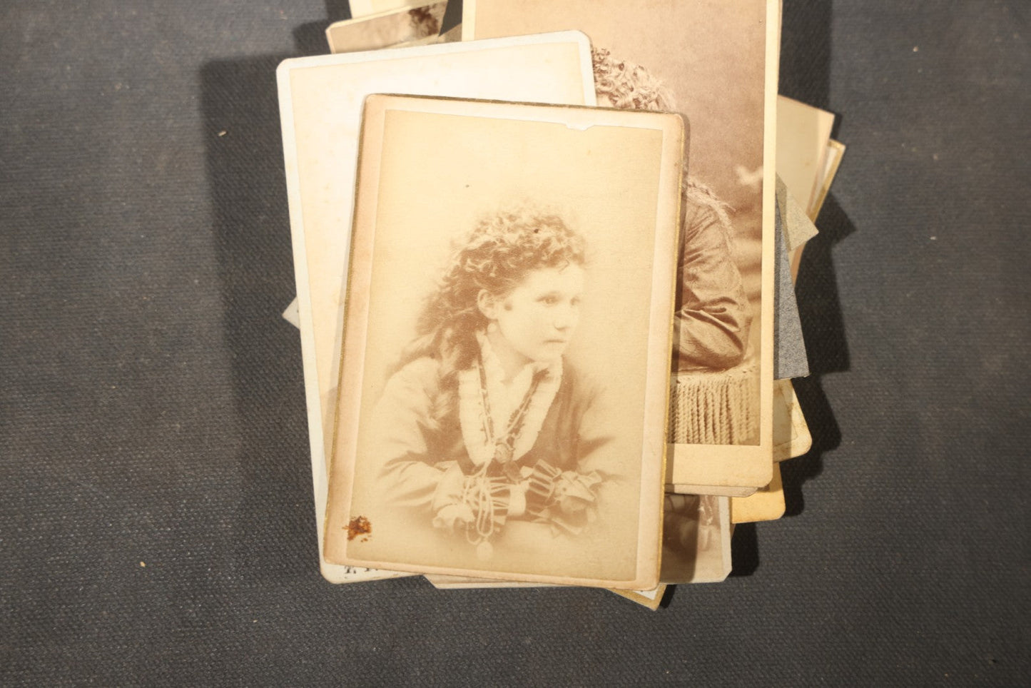 Grouping of 40+ Antique Photographs Including Carte De Visite C.D.V. Portraits, Tintype Photographs, and Board-Mounted Photographs, including young children, women with curled bangs, and more