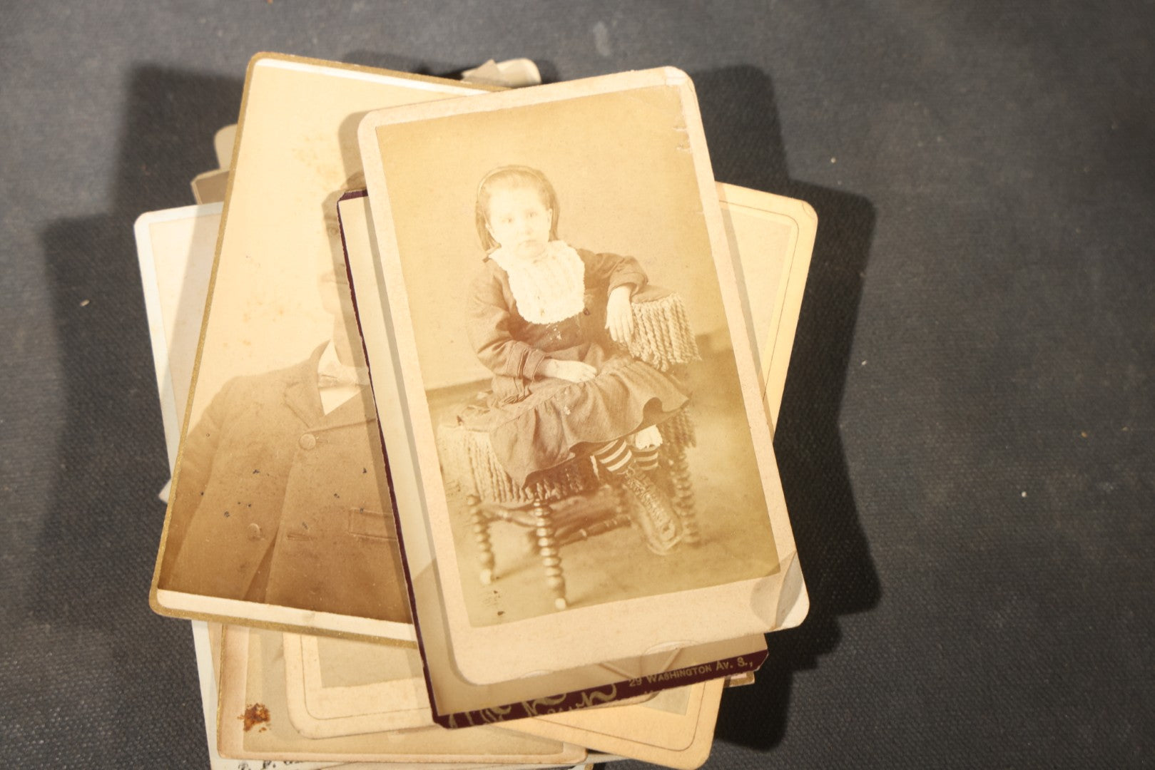 Grouping of 40+ Antique Photographs Including Carte De Visite C.D.V. Portraits, Tintype Photographs, and Board-Mounted Photographs, including young children, women with curled bangs, and more