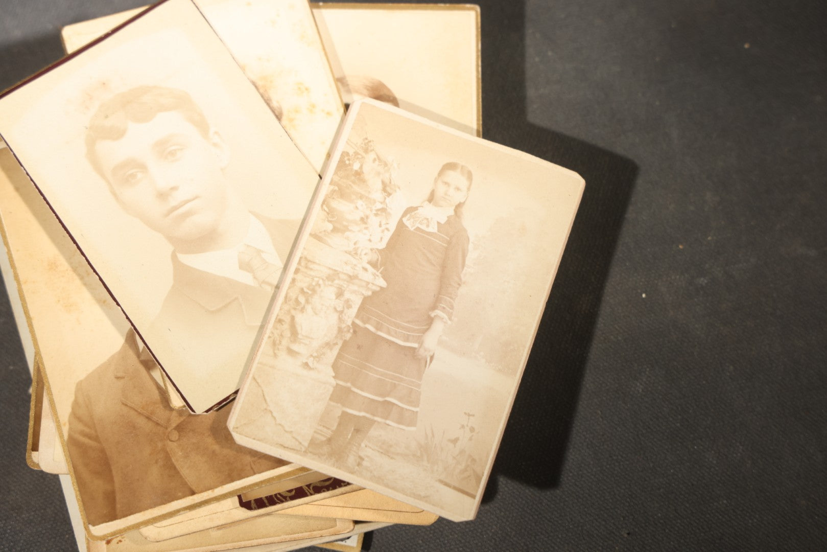 Grouping of 40+ Antique Photographs Including Carte De Visite C.D.V. Portraits, Tintype Photographs, and Board-Mounted Photographs, including young children, women with curled bangs, and more