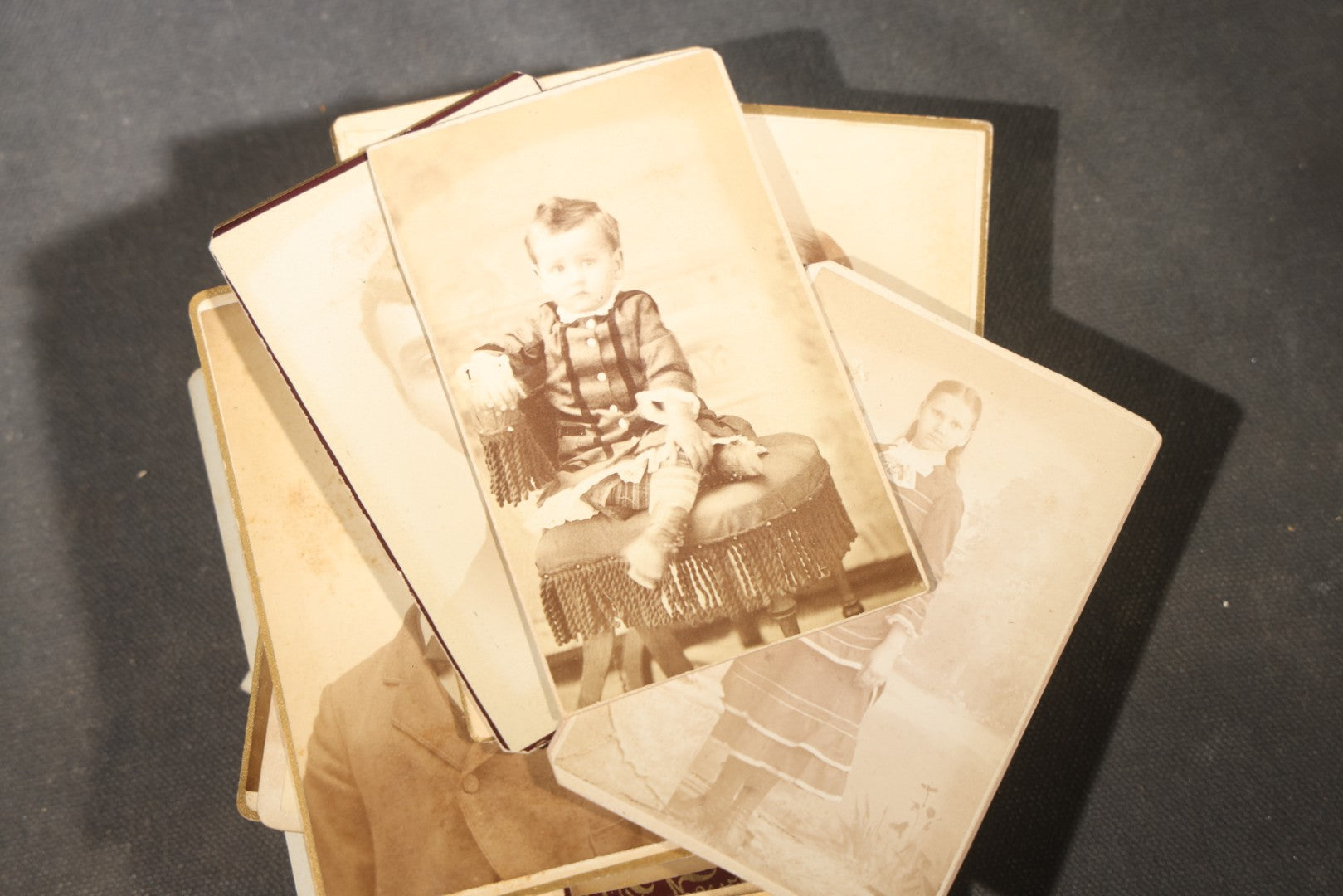 Grouping of 40+ Antique Photographs Including Carte De Visite C.D.V. Portraits, Tintype Photographs, and Board-Mounted Photographs, including young children, women with curled bangs, and more