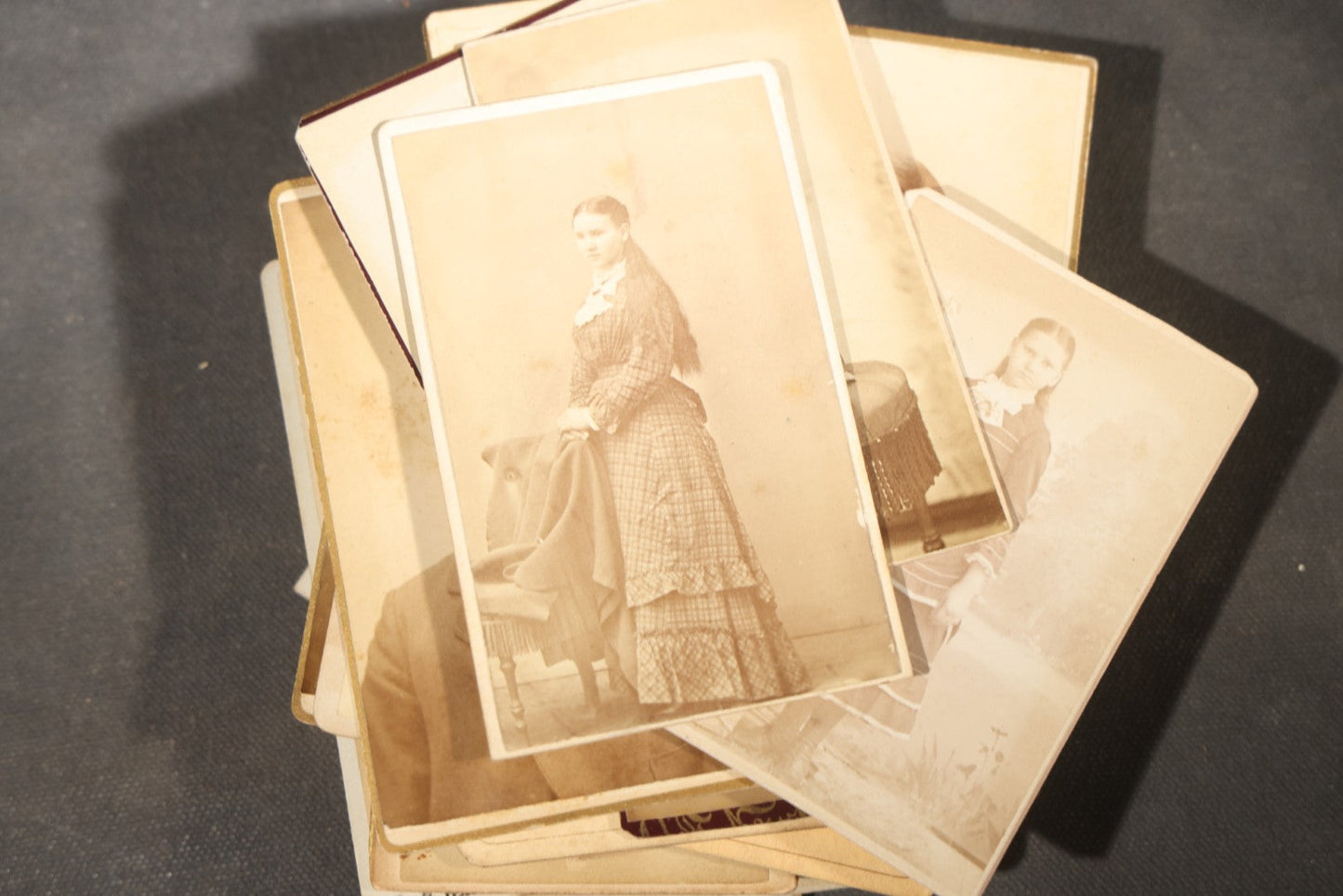 Grouping of 40+ Antique Photographs Including Carte De Visite C.D.V. Portraits, Tintype Photographs, and Board-Mounted Photographs, including young children, women with curled bangs, and more