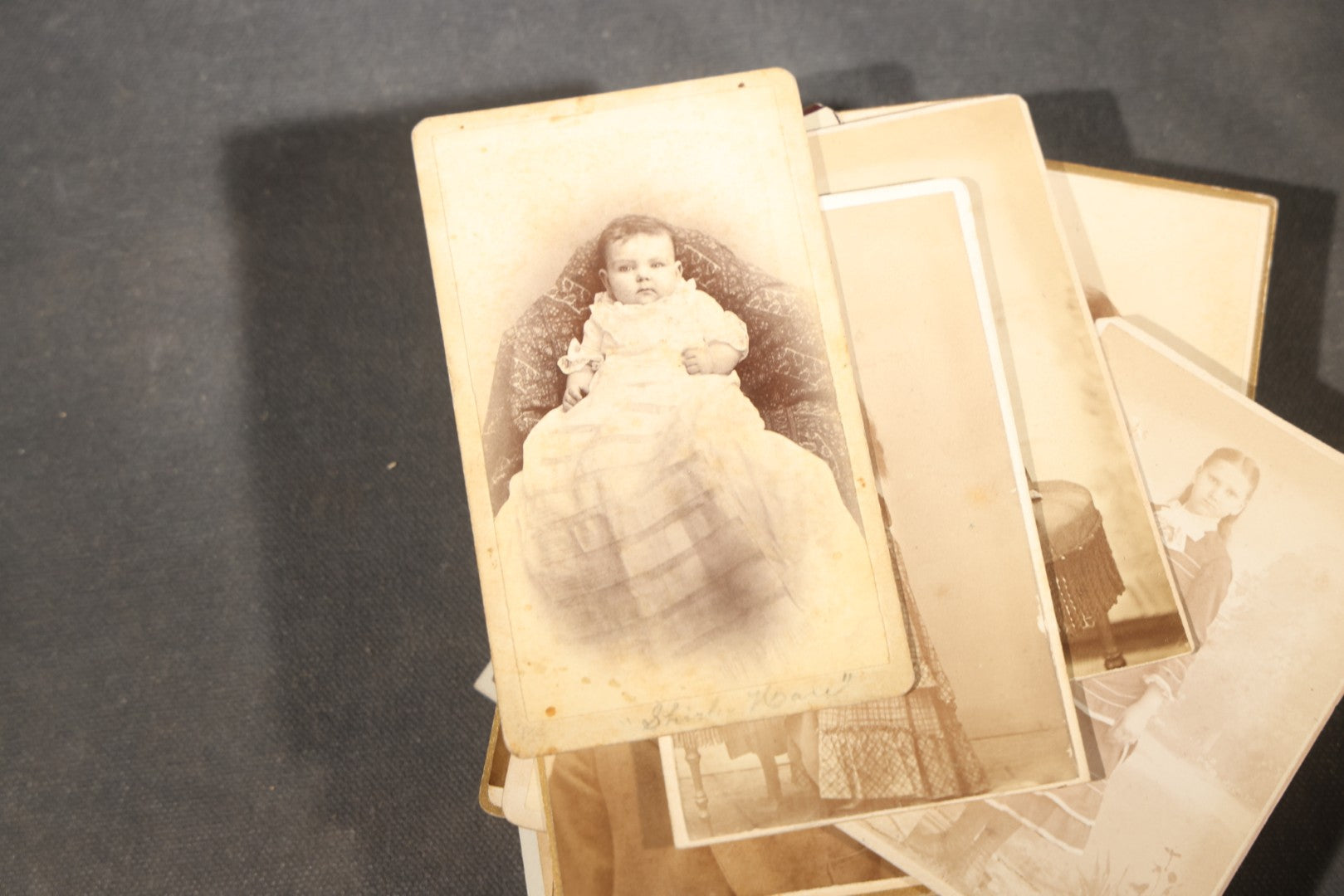 Grouping of 40+ Antique Photographs Including Carte De Visite C.D.V. Portraits, Tintype Photographs, and Board-Mounted Photographs, including young children, women with curled bangs, and more
