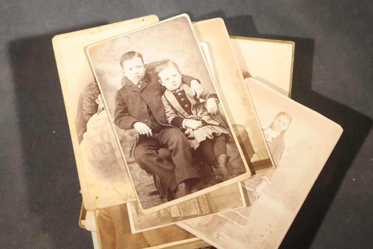 Grouping of 40+ Antique Photographs Including Carte De Visite C.D.V. Portraits, Tintype Photographs, and Board-Mounted Photographs, including young children, women with curled bangs, and more