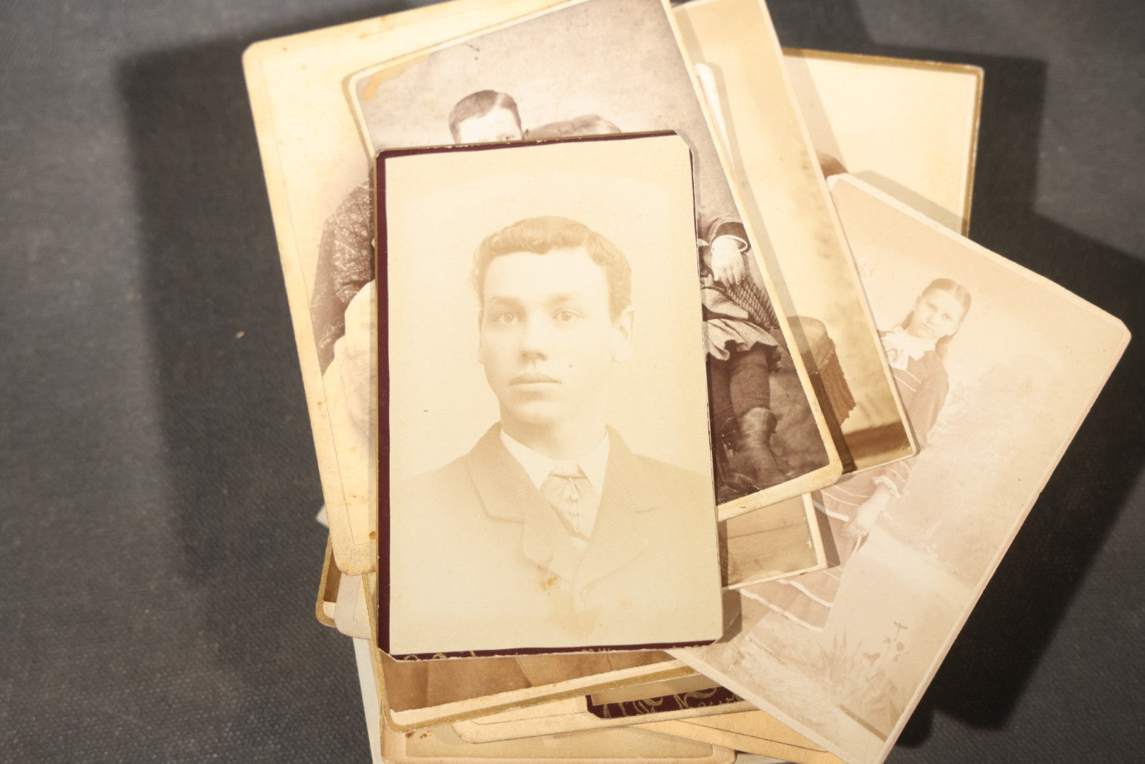 Grouping of 40+ Antique Photographs Including Carte De Visite C.D.V. Portraits, Tintype Photographs, and Board-Mounted Photographs, including young children, women with curled bangs, and more