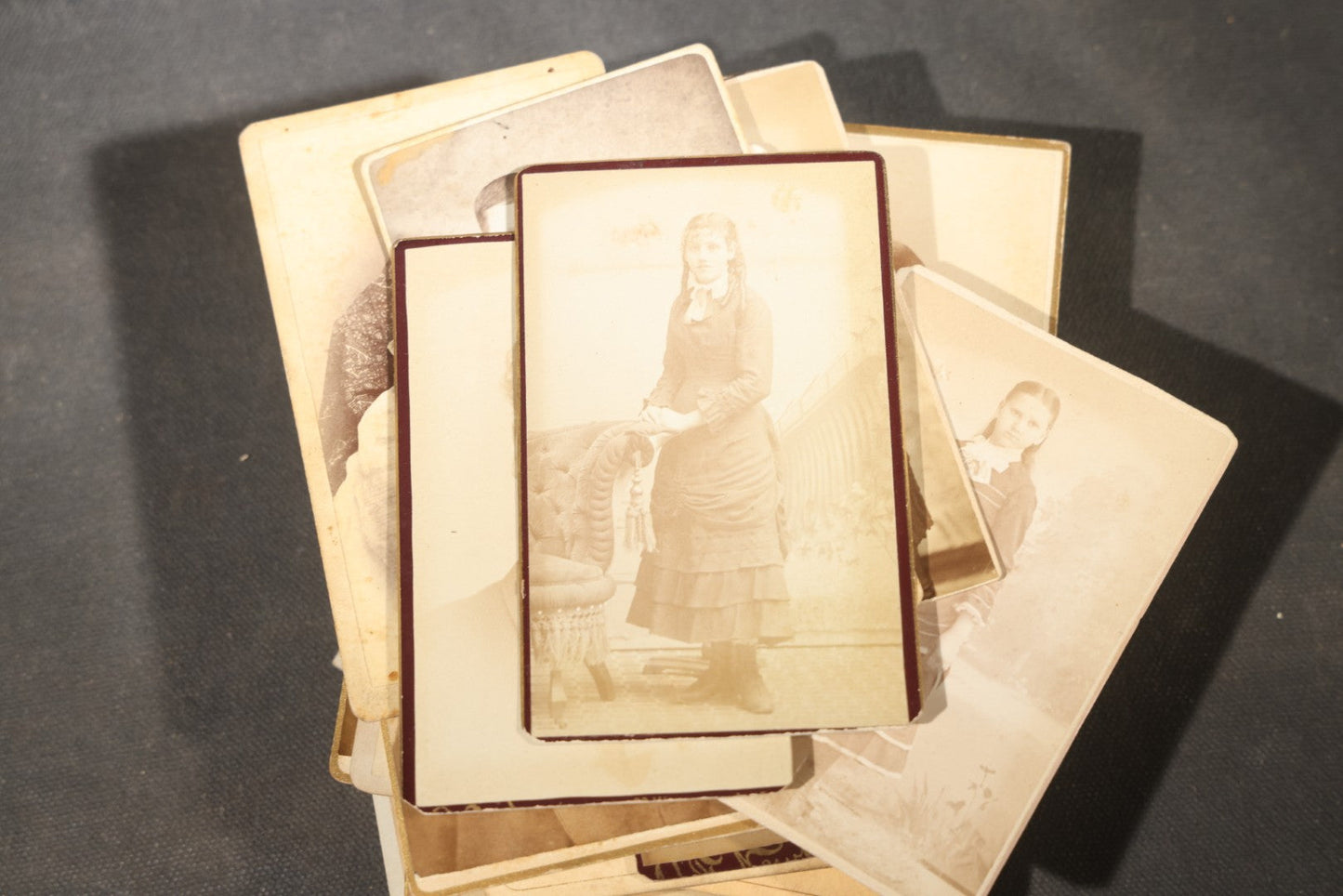 Grouping of 40+ Antique Photographs Including Carte De Visite C.D.V. Portraits, Tintype Photographs, and Board-Mounted Photographs, including young children, women with curled bangs, and more