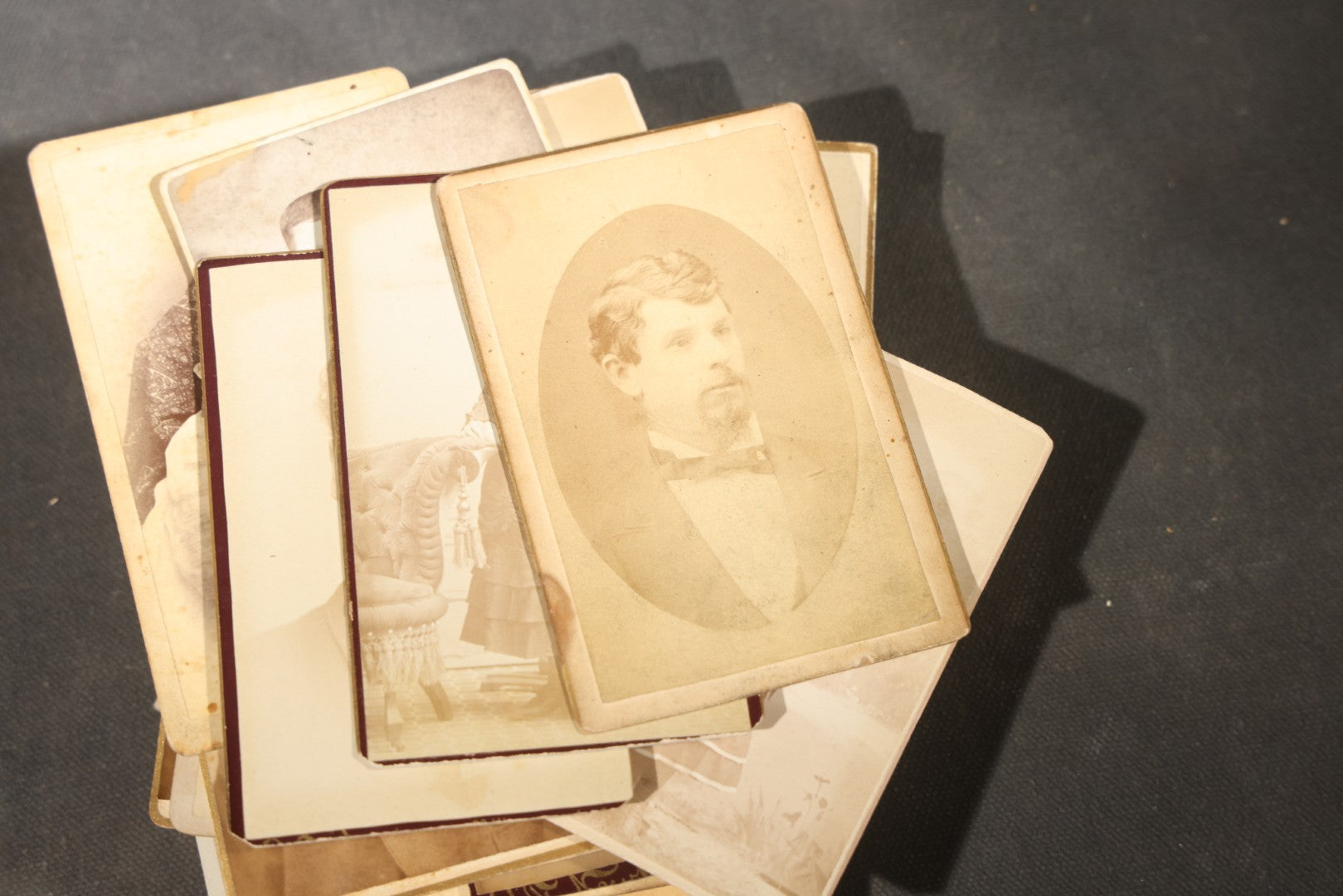 Grouping of 40+ Antique Photographs Including Carte De Visite C.D.V. Portraits, Tintype Photographs, and Board-Mounted Photographs, including young children, women with curled bangs, and more