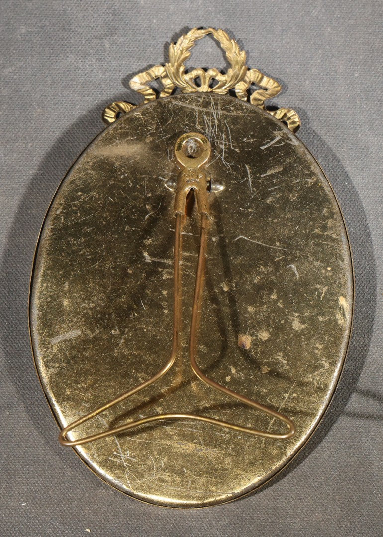 Pair of Antique Framed Oval Portrait Photographs of a Young Soldier and a Young Girl in Brass Frames with Convex Glass