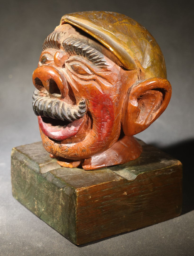 Vintage Folk Art Carved and Painted Wooden Caricature Head of a Mustached Man in a Cap on Removable Block Base, Chip to Hat