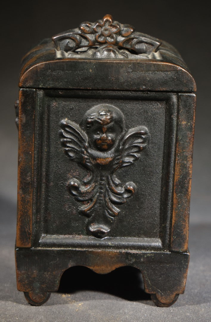 Antique Cast Iron Cherub Still Bank with Winged Putti Panels and Floral Lid Handle, Kenton Brand, Patented August 22, 1911