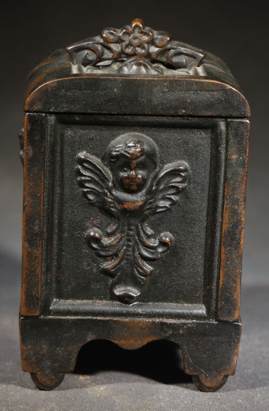 Antique Cast Iron Cherub Still Bank with Winged Putti Panels and Floral Lid Handle, Kenton Brand, Patented August 22, 1911