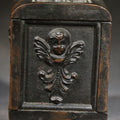 Lot 201 - Antique Cast Iron Cherub Still Bank with Winged Putti Panels and Floral Lid Handle, Kenton Brand, Patented August 22, 1911, 5" H
