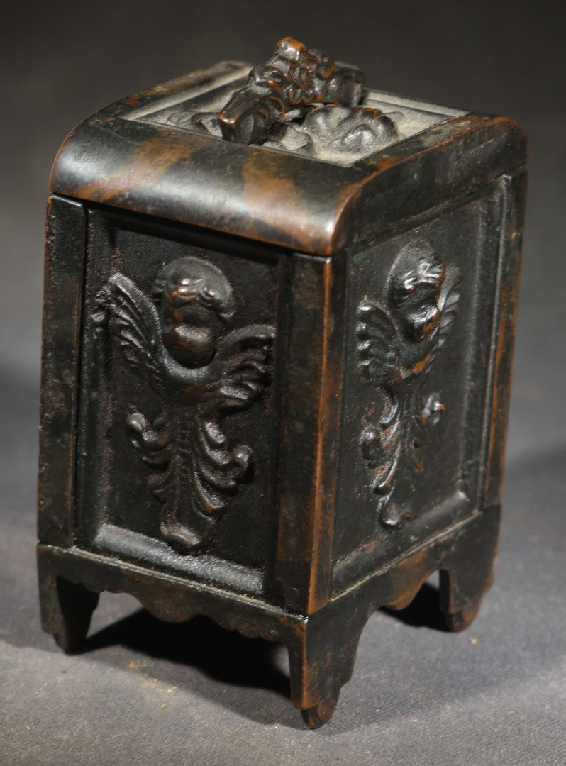 Antique Cast Iron Cherub Still Bank with Winged Putti Panels and Floral Lid Handle, Kenton Brand, Patented August 22, 1911