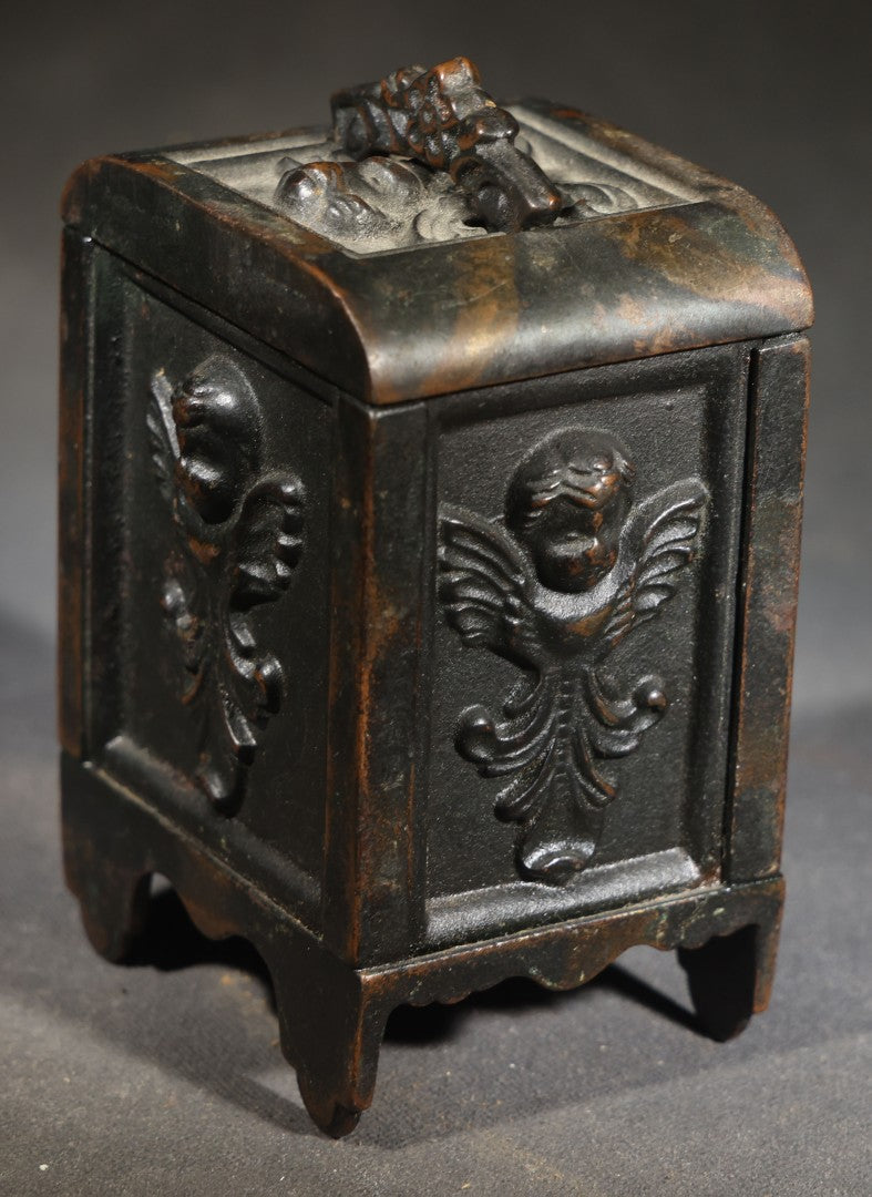 Antique Cast Iron Cherub Still Bank with Winged Putti Panels and Floral Lid Handle, Kenton Brand, Patented August 22, 1911