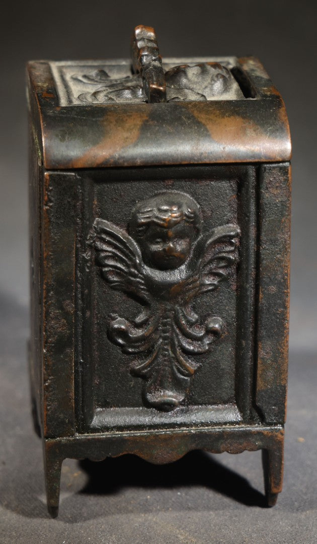 Antique Cast Iron Cherub Still Bank with Winged Putti Panels and Floral Lid Handle, Kenton Brand, Patented August 22, 1911