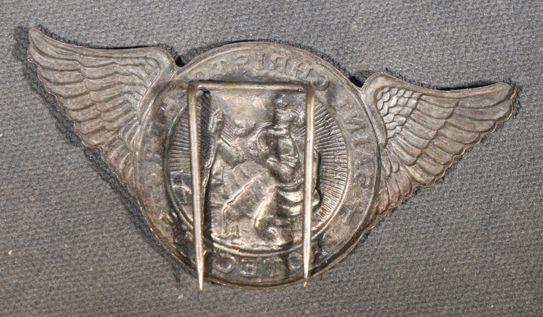 Trio of Vintage Catholic Automobile Visor Clips including Saint Christopher Winged Badge, Saint Christopher and Crucifix Three-Panel Badge, and Saint Christopher with Our Lady of the Miraculous Medal