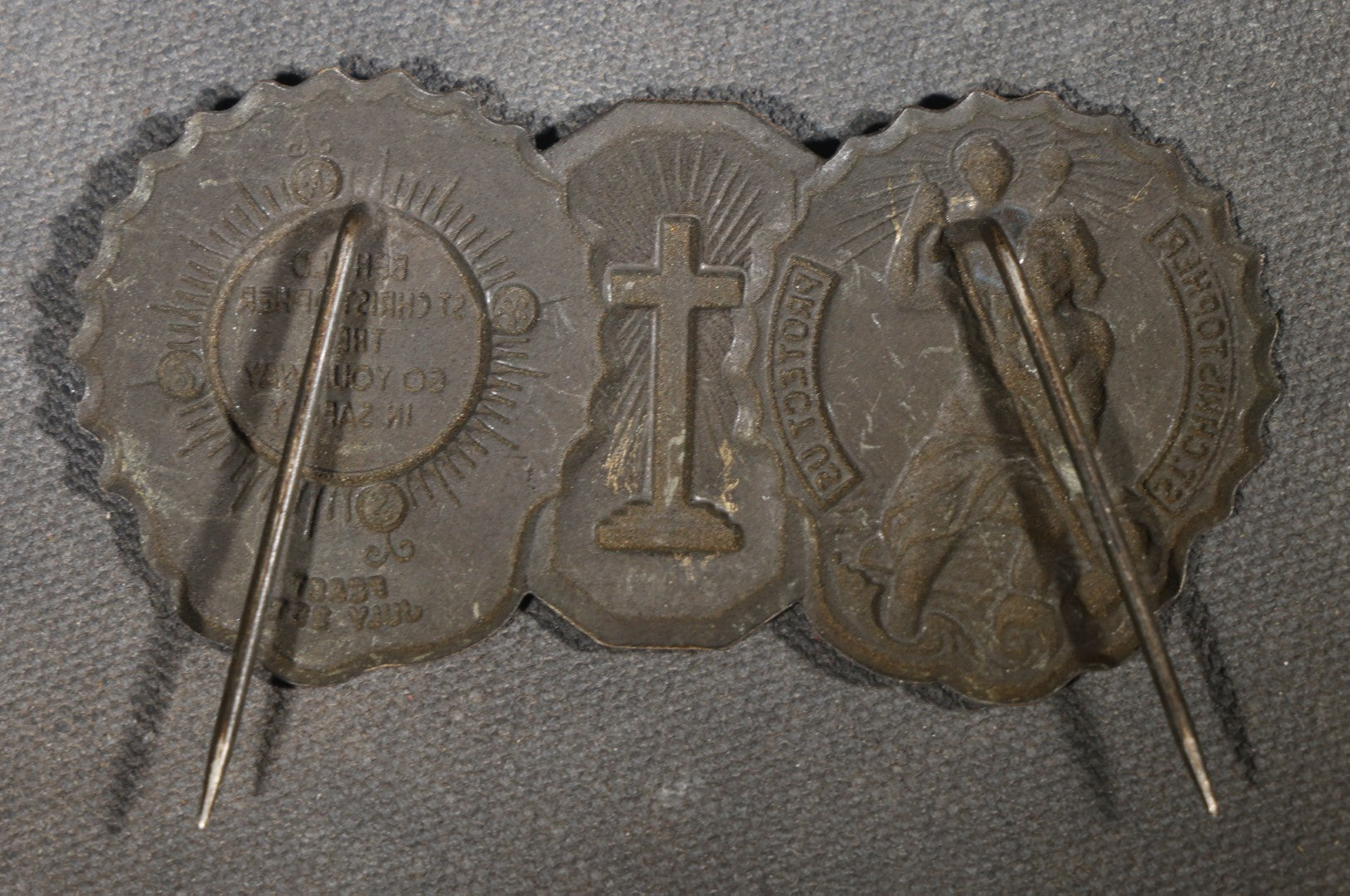 Trio of Vintage Catholic Automobile Visor Clips including Saint Christopher Winged Badge, Saint Christopher and Crucifix Three-Panel Badge, and Saint Christopher with Our Lady of the Miraculous Medal
