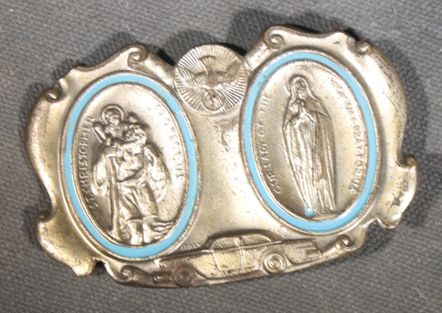 Trio of Vintage Catholic Automobile Visor Clips including Saint Christopher Winged Badge, Saint Christopher and Crucifix Three-Panel Badge, and Saint Christopher with Our Lady of the Miraculous Medal
