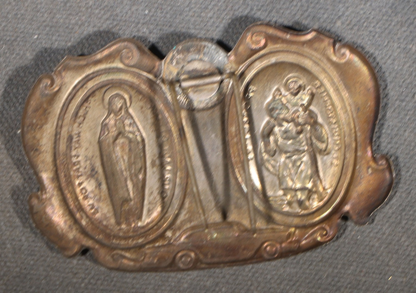 Trio of Vintage Catholic Automobile Visor Clips including Saint Christopher Winged Badge, Saint Christopher and Crucifix Three-Panel Badge, and Saint Christopher with Our Lady of the Miraculous Medal