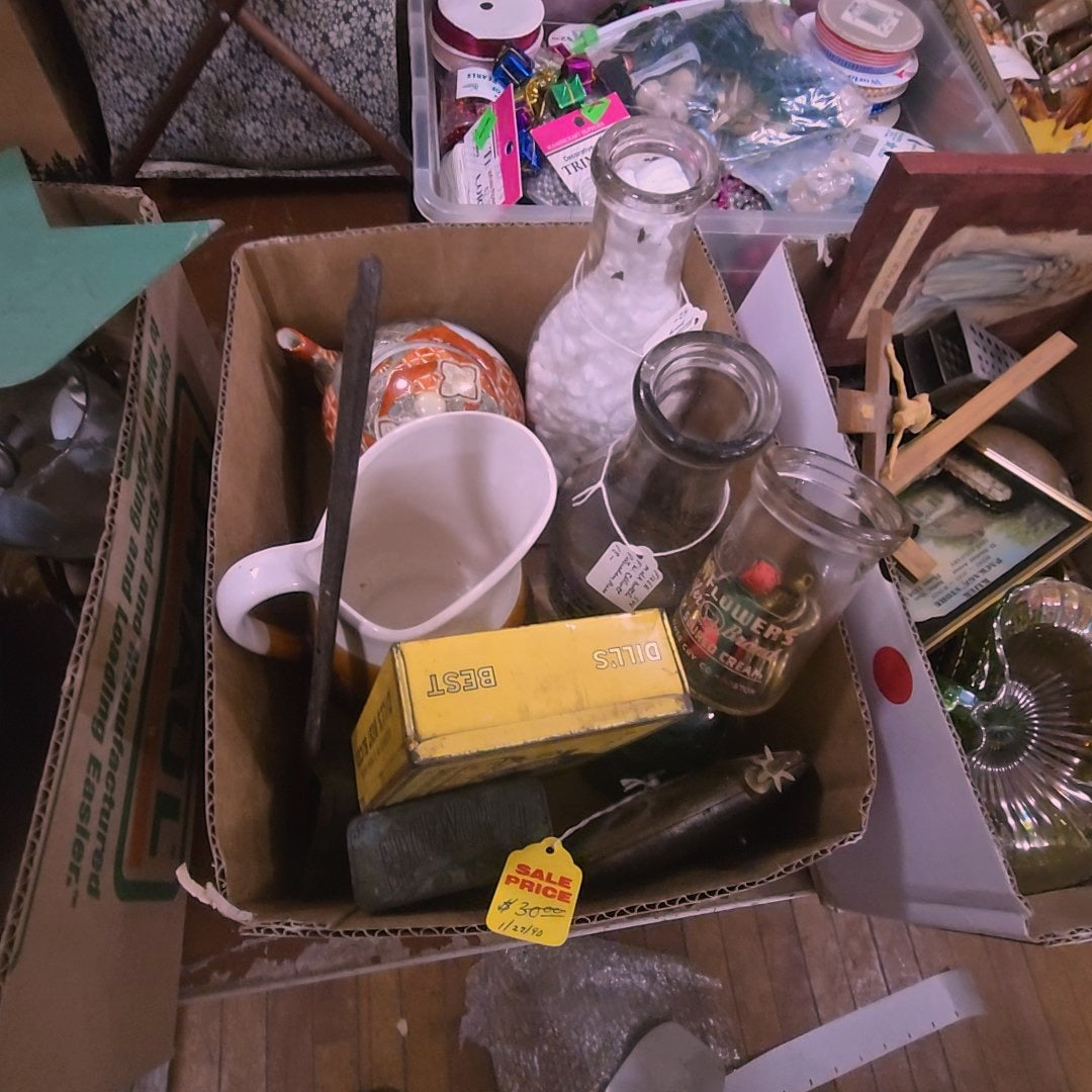 Box lot with milk bottles, tins, clock pendulum, and more