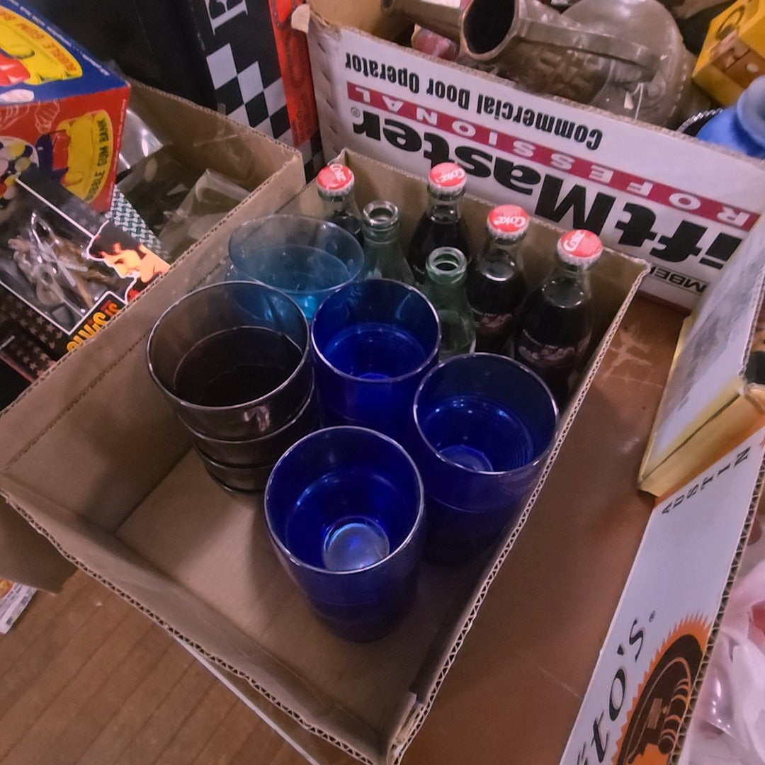 box lot with blue glass cups and Coke bottles