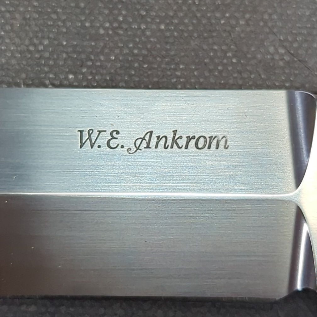 W.E. Ankrom Wilderness Knife, Amber Stag Scales, Stainless Steel Hilt with Scroll Engraving, Tooled Leather Belt Sheath by Paul Long, Kerrville, Texas, Note Fine Crack on Front Side of Handle