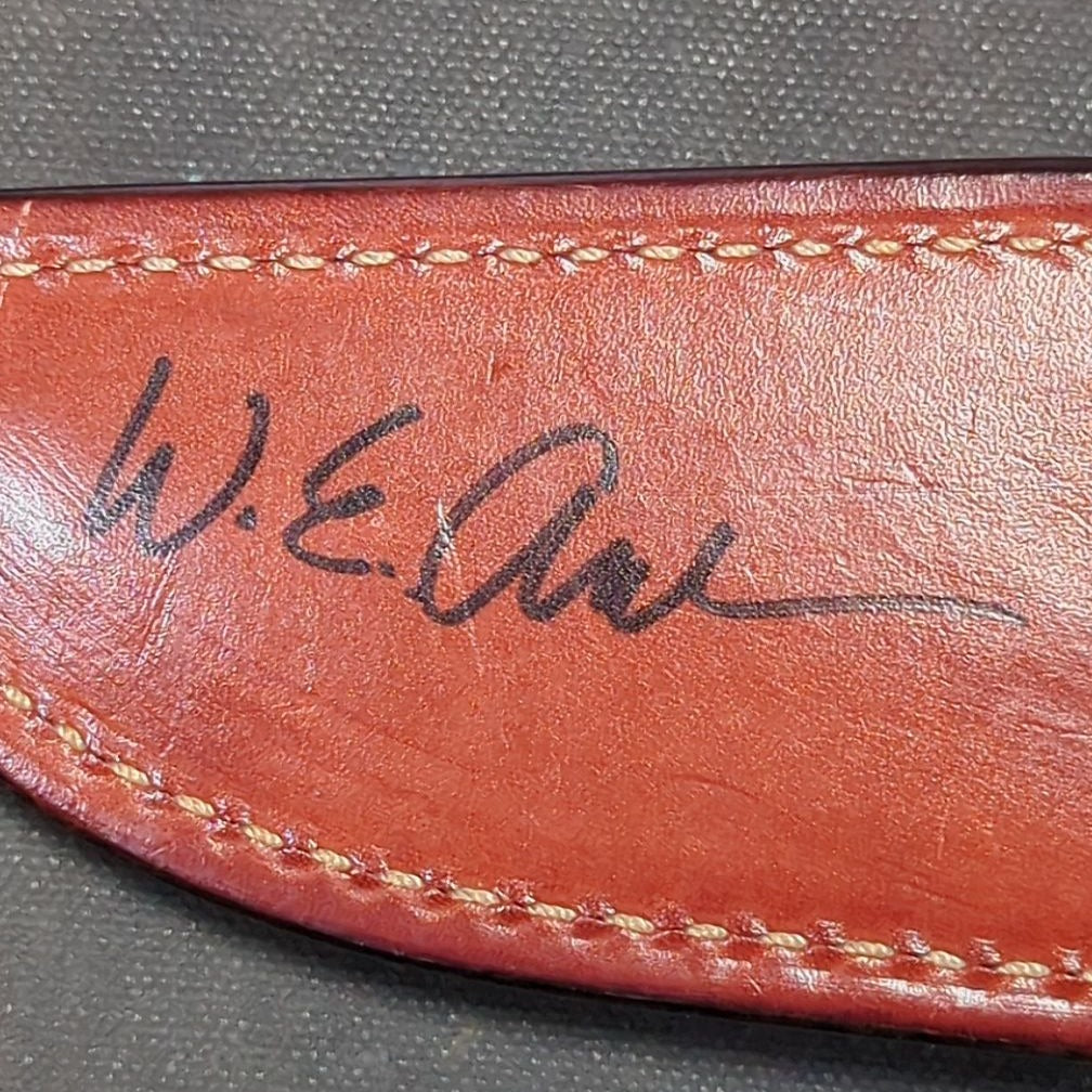 W.E. Ankrom Wilderness Knife, Amber Stag Scales, Stainless Steel Hilt with Scroll Engraving, Tooled Leather Belt Sheath by Paul Long, Kerrville, Texas, Note Fine Crack on Front Side of Handle