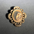 Lot 005 - Antique Gold-Tone Hair Work Brooch with Woven Hair Under Glass in Scroll and Floral Frame, 1-5/8" W x 1-7/8" H