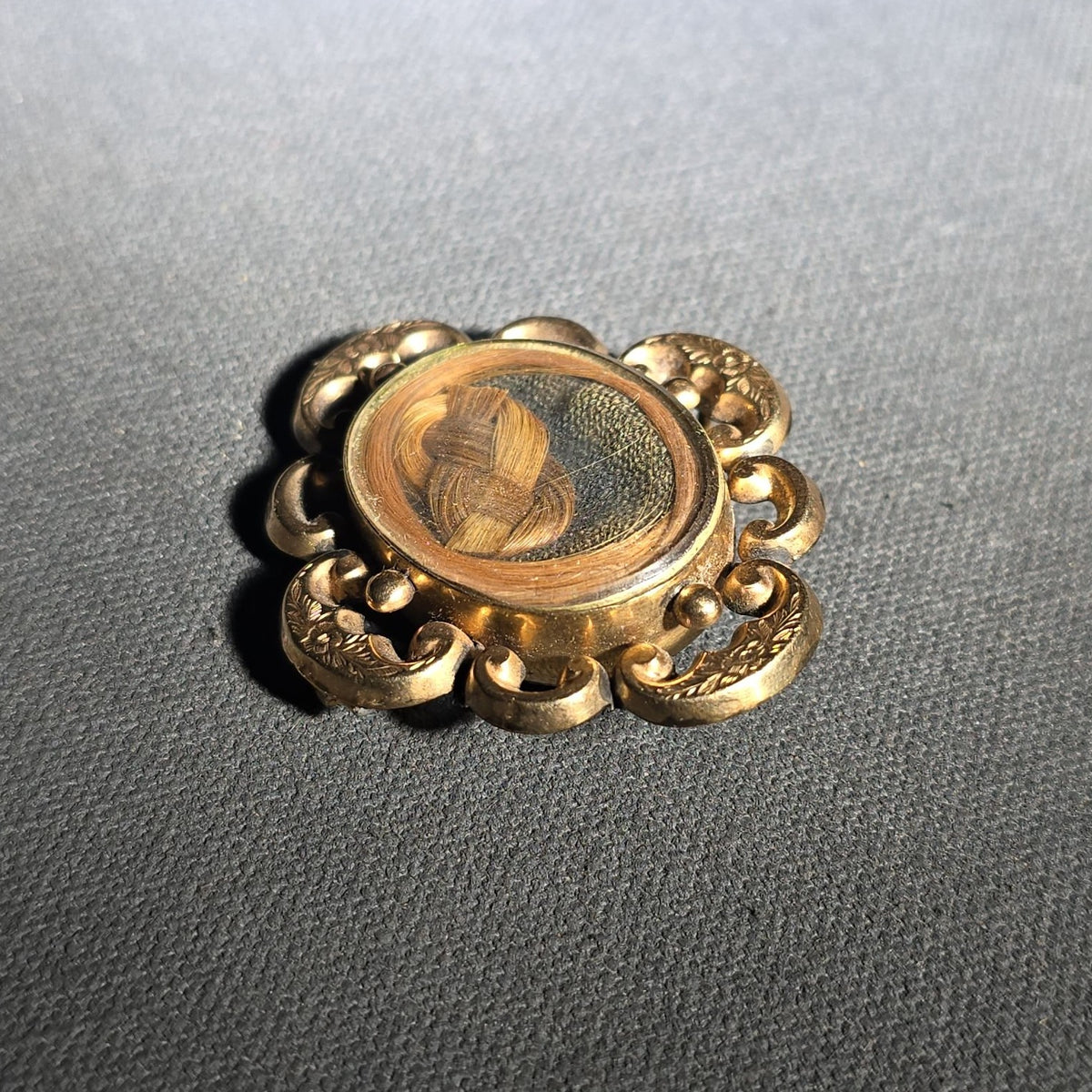 Antique Gold-Tone Hair Work Brooch with Woven Hair Under Glass in Scroll and Floral Frame