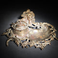 Lot 131 - Antique Cast Metal Rococo-Style Inkstand with Cherub Finial, Glass Ink Insert, Hinged Lid, and Shell-Form Pen Tray, 8" L