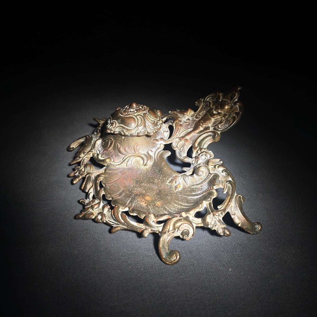 Antique Cast Metal Rococo-Style Inkstand with Cherub Finial, Glass Ink Insert, Hinged Lid, and Shell-Form Pen Tray