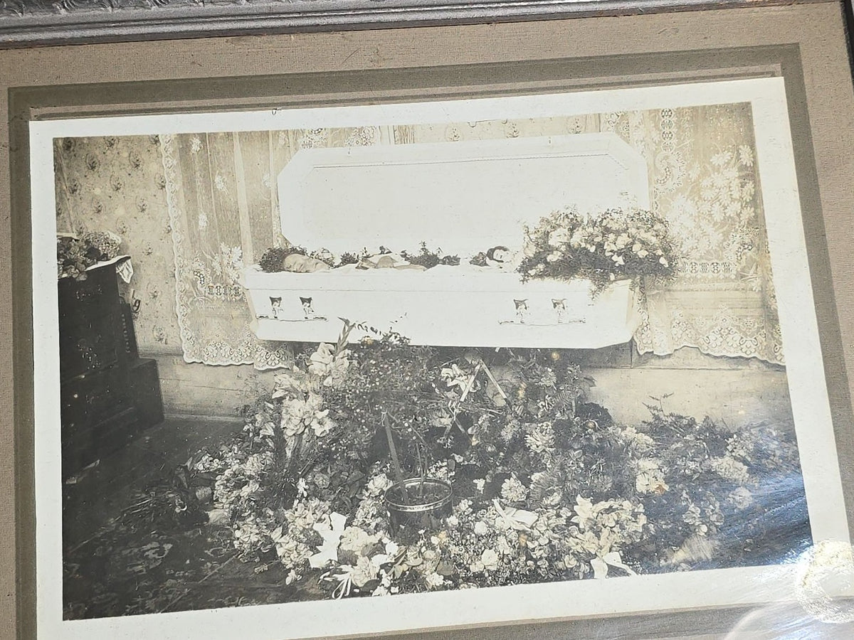 Antique Framed Funeral Photograph of a Child in Open Casket Surrounded by Floral Arrangements