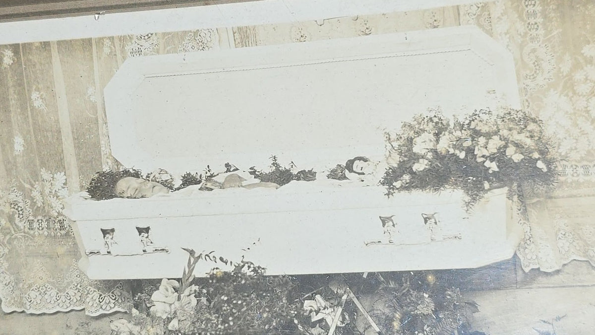 Antique Framed Funeral Photograph of a Child in Open Casket Surrounded by Floral Arrangements