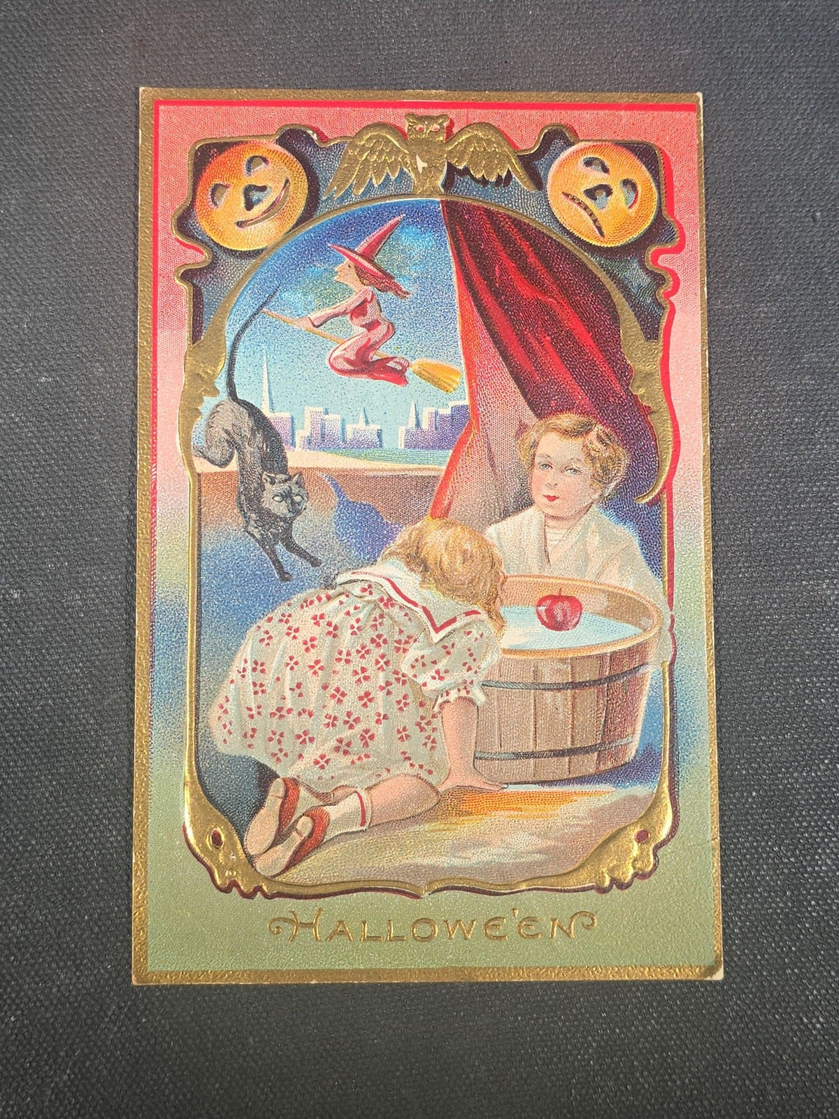 Antique Embossed Halloween Postcard with Children Bobbing for Apples, Jack-O-Lanterns, Black Cat, and Witch on Broomstick, Halloween Series No. 5, Postmarked Providence, Rhode Island, 1910