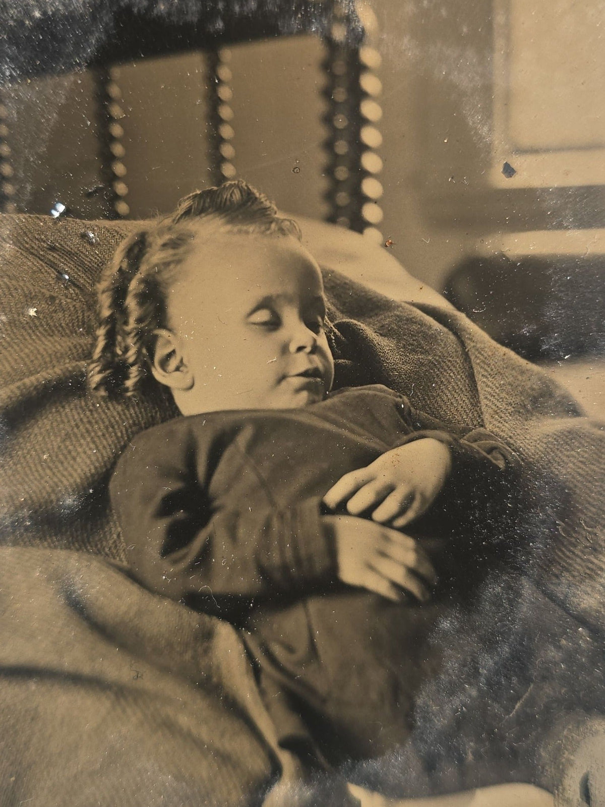 Antique Tintype Photograph of a Young Child Reclined on a Pillow, Likely Postmortem