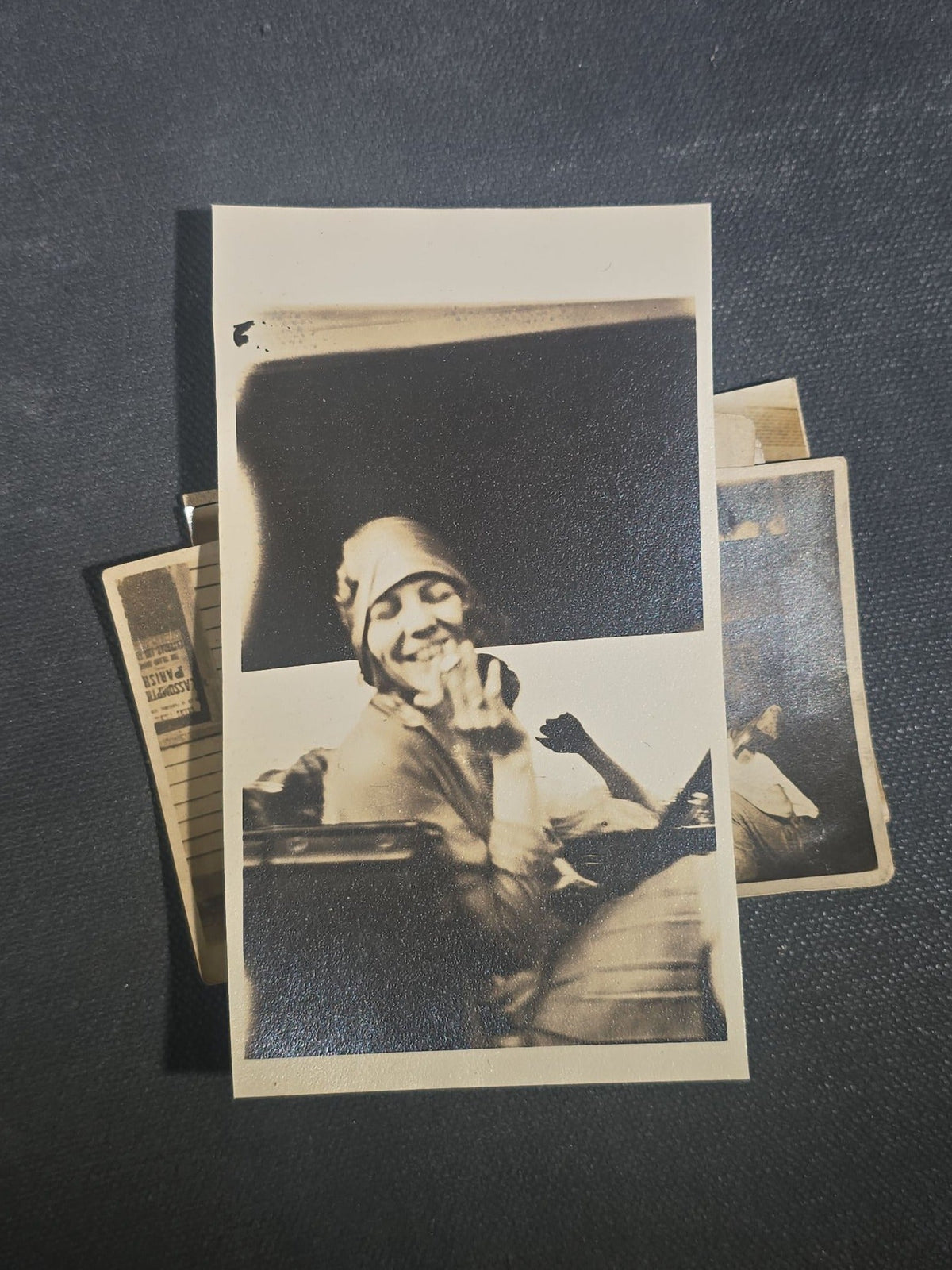 Grouping of Eight Antique and Vintage Snapshot Photographs including Boys Gambling on a Sidewalk, Clown on Stoop, Silhouette of Two Figures on a Shore, and a Group Portrait Outside
