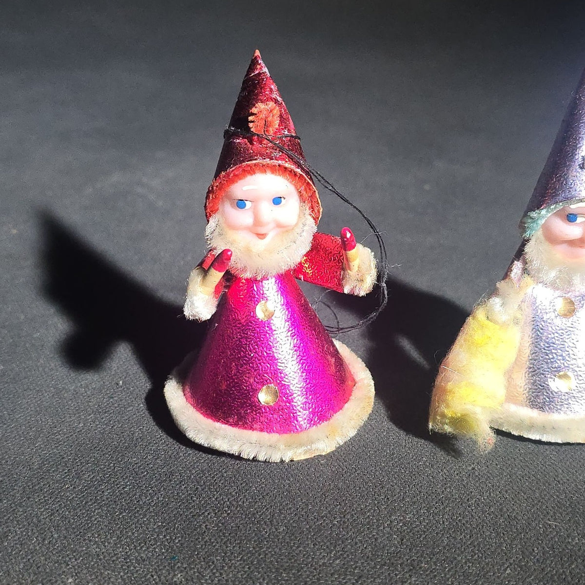 Grouping of Four Vintage Japanese Santa Claus Christmas Ornaments in Metallic Foil Cone Robes with Pipe Cleaner Arms