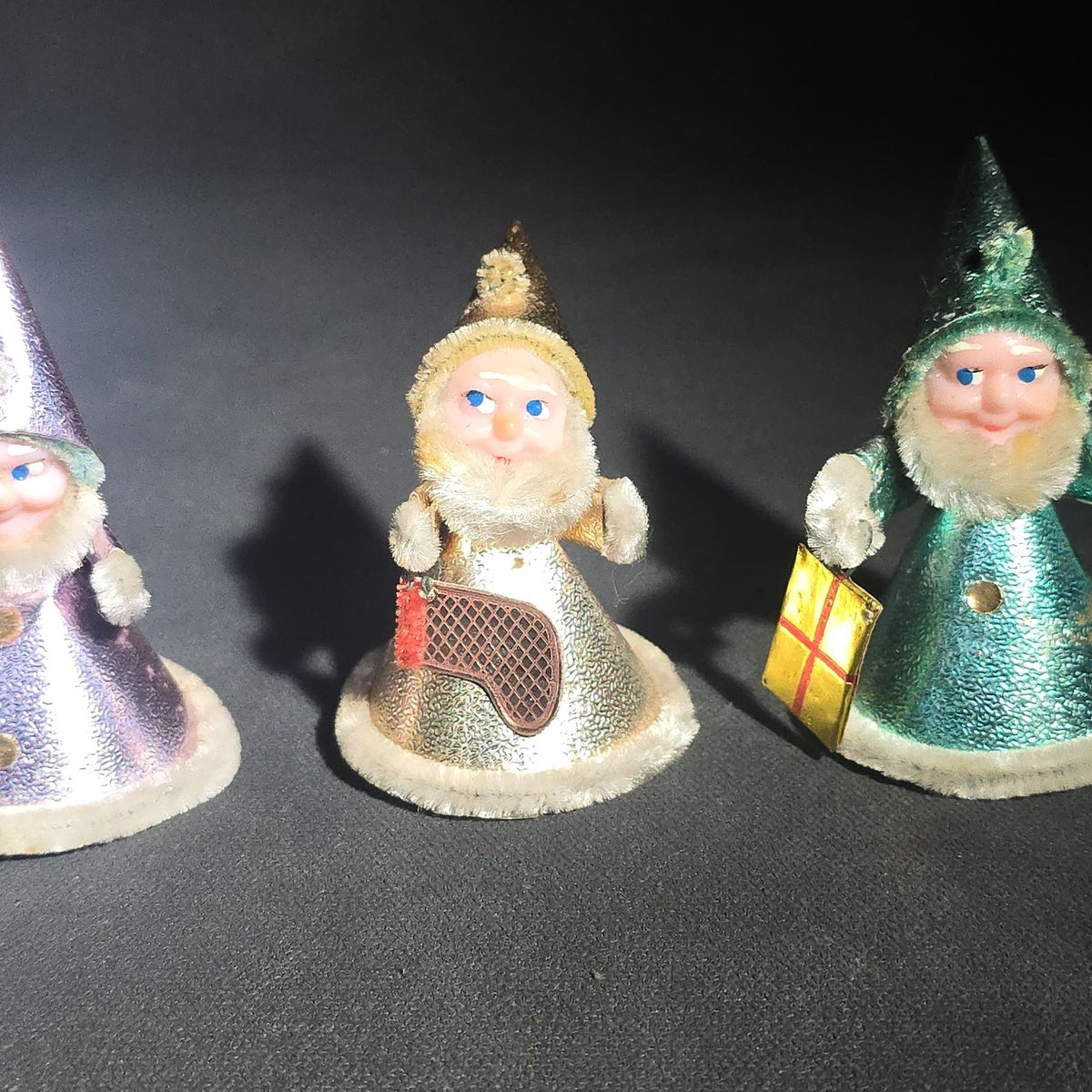 Grouping of Four Vintage Japanese Santa Claus Christmas Ornaments in Metallic Foil Cone Robes with Pipe Cleaner Arms