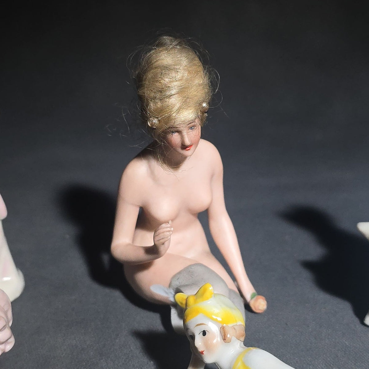 Grouping of Eight Vintage Porcelain Bathing Beauty and Nude Figurines including Reclining, Seated, and Standing Poses in Swimsuits and Nude Forms