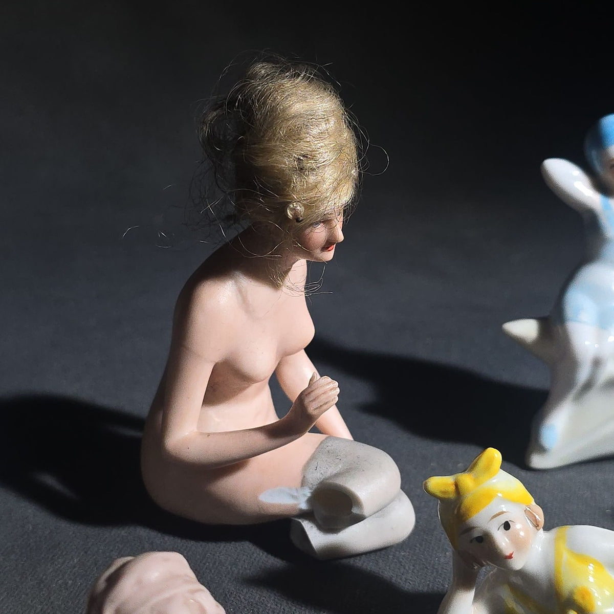 Grouping of Eight Vintage Porcelain Bathing Beauty and Nude Figurines including Reclining, Seated, and Standing Poses in Swimsuits and Nude Forms