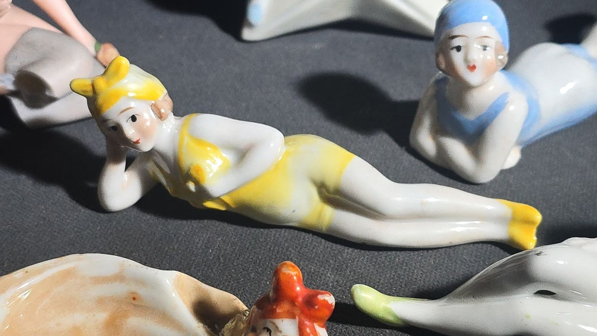 Grouping of Eight Vintage Porcelain Bathing Beauty and Nude Figurines including Reclining, Seated, and Standing Poses in Swimsuits and Nude Forms