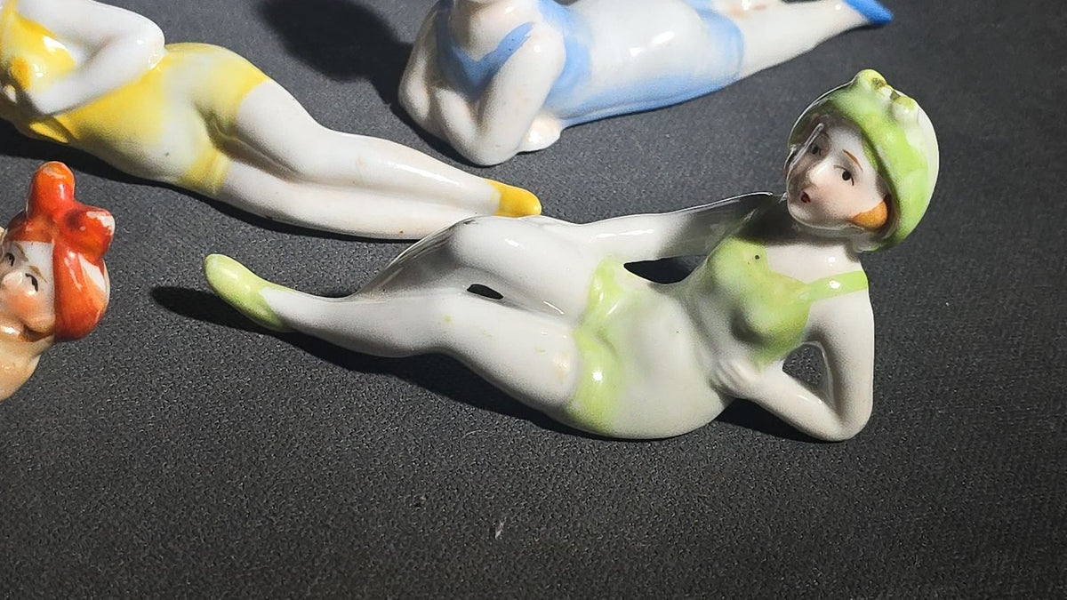 Grouping of Eight Vintage Porcelain Bathing Beauty and Nude Figurines including Reclining, Seated, and Standing Poses in Swimsuits and Nude Forms