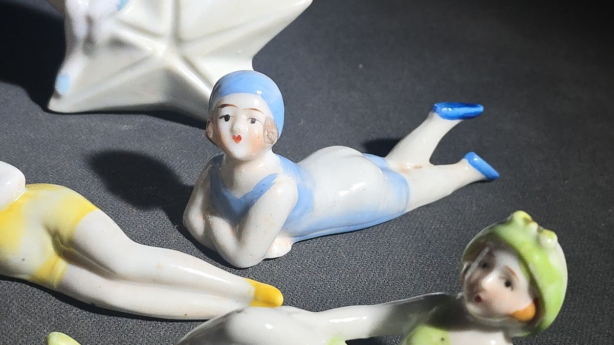 Grouping of Eight Vintage Porcelain Bathing Beauty and Nude Figurines including Reclining, Seated, and Standing Poses in Swimsuits and Nude Forms