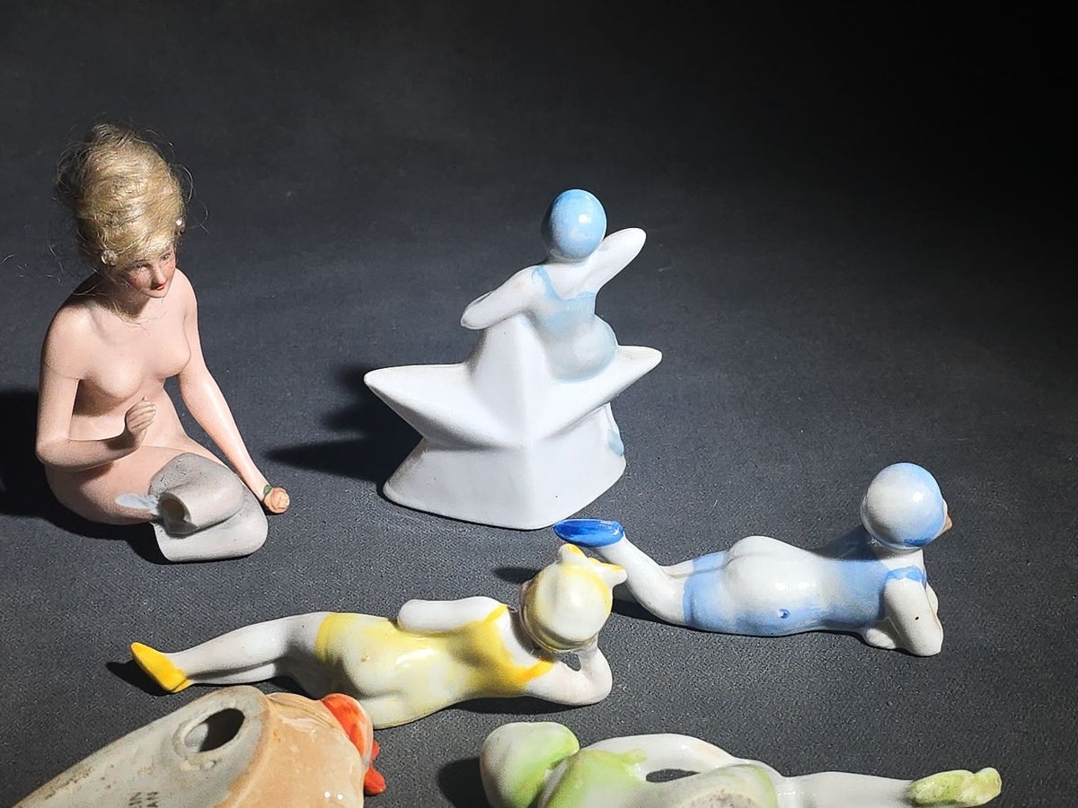 Grouping of Eight Vintage Porcelain Bathing Beauty and Nude Figurines including Reclining, Seated, and Standing Poses in Swimsuits and Nude Forms