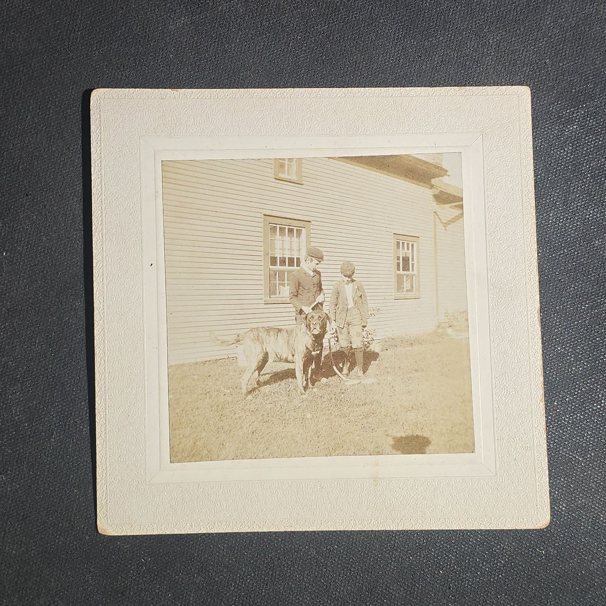 Grouping of Seven Antique Board-Mounted Photographs including Homes, Log Cabin, Children with Dog, and Band Director with Brass Instrument, Proctor, Vermont, Circa 1880s-1890s