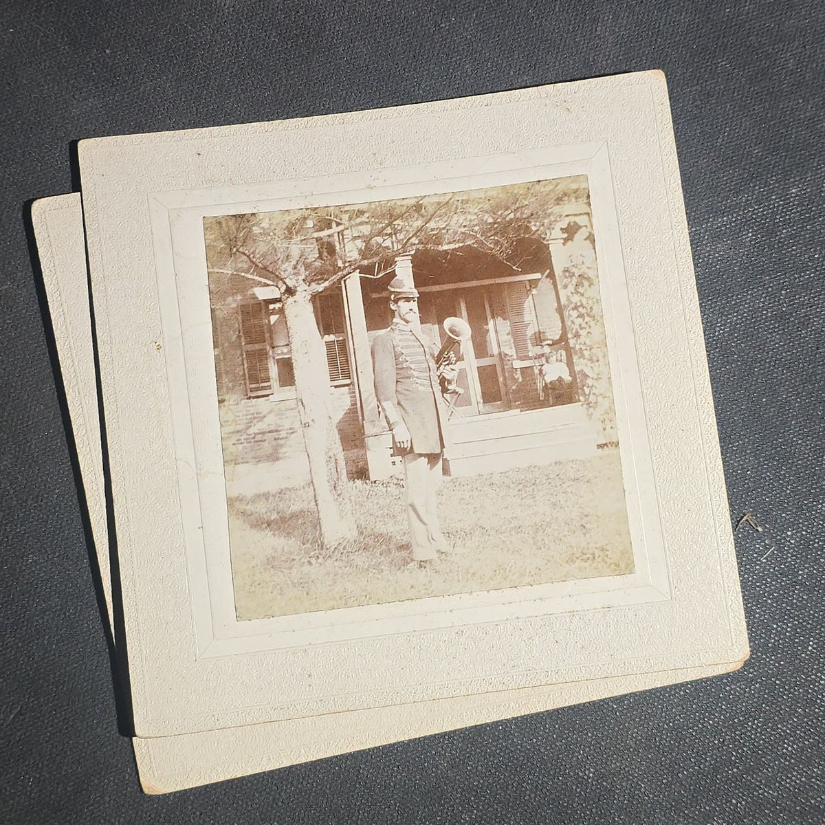 Grouping of Seven Antique Board-Mounted Photographs including Homes, Log Cabin, Children with Dog, and Band Director with Brass Instrument, Proctor, Vermont, Circa 1880s-1890s