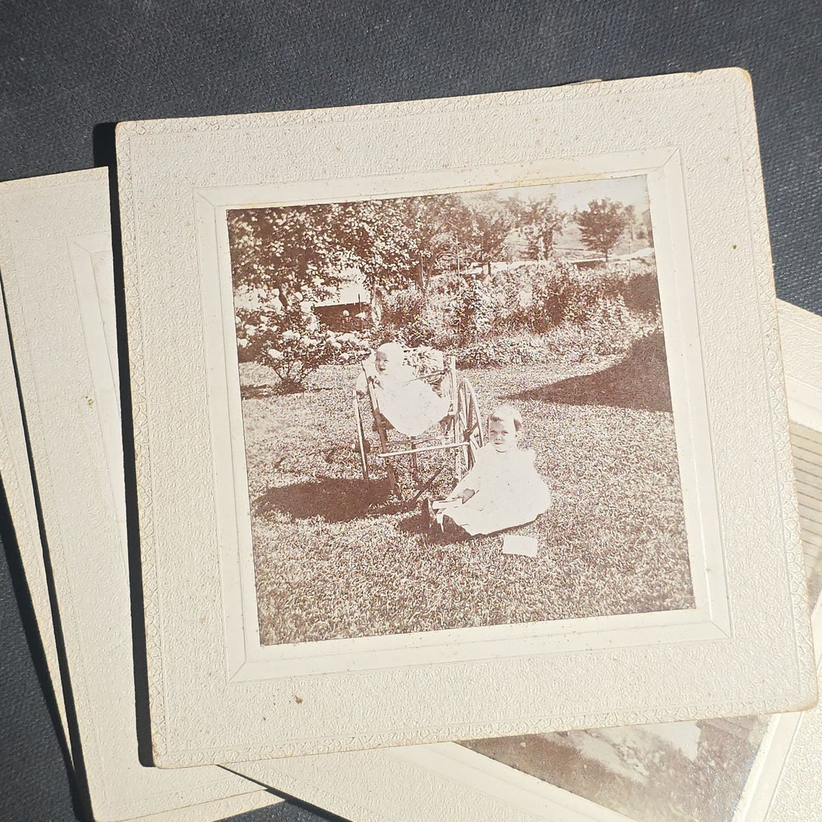 Grouping of Seven Antique Board-Mounted Photographs including Homes, Log Cabin, Children with Dog, and Band Director with Brass Instrument, Proctor, Vermont, Circa 1880s-1890s