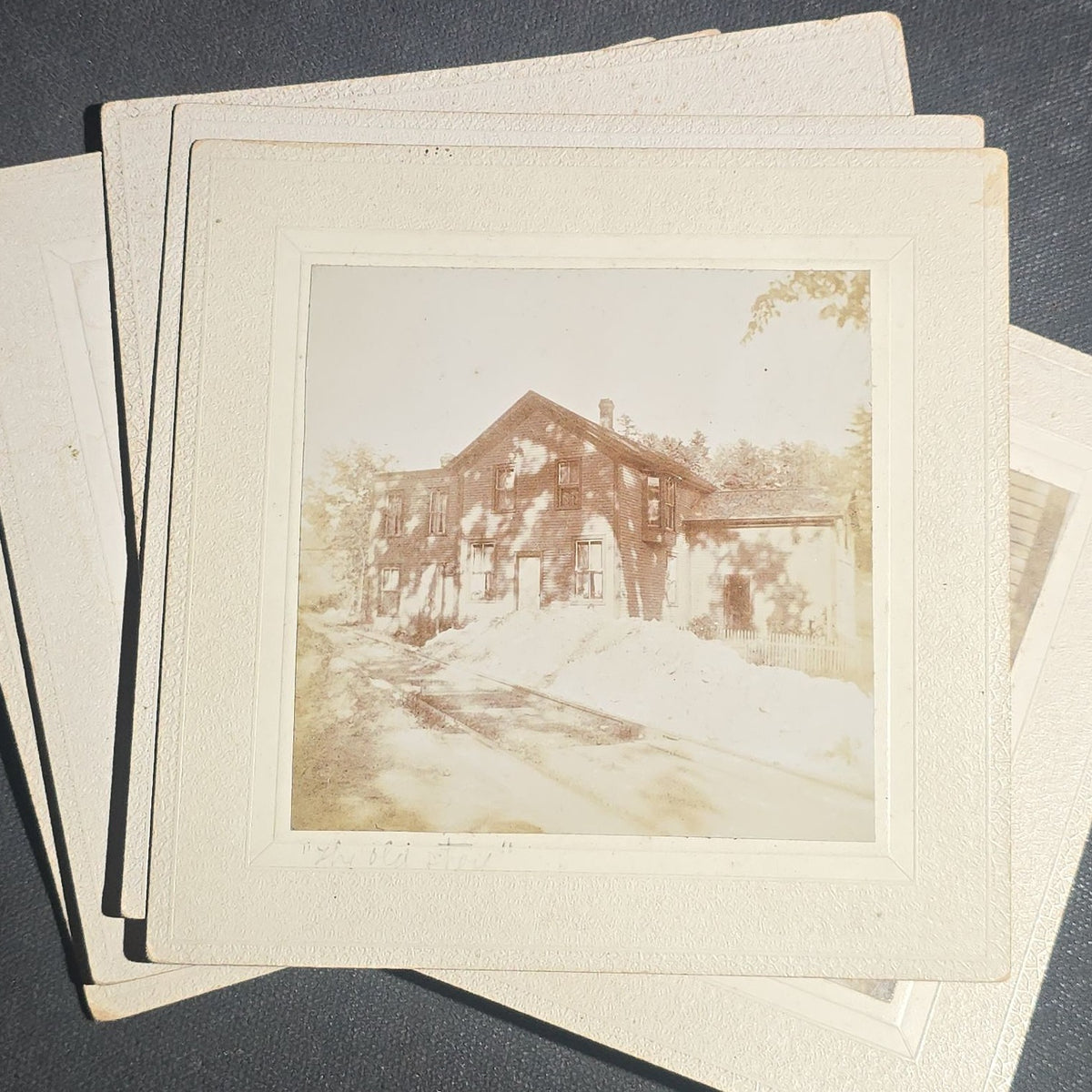 Grouping of Seven Antique Board-Mounted Photographs including Homes, Log Cabin, Children with Dog, and Band Director with Brass Instrument, Proctor, Vermont, Circa 1880s-1890s