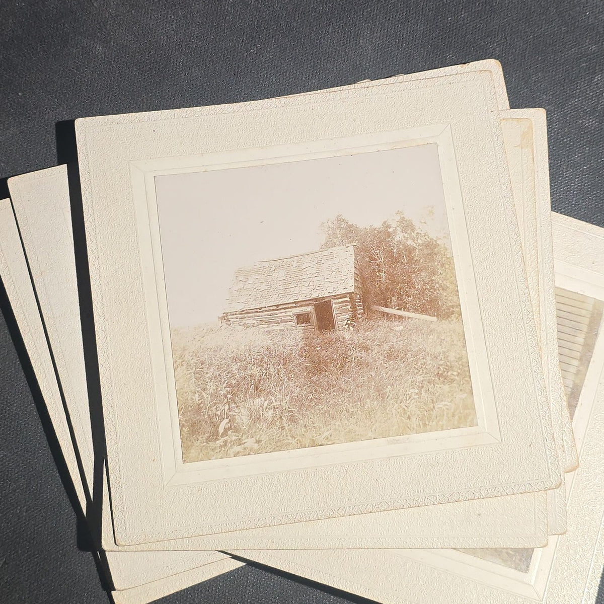 Grouping of Seven Antique Board-Mounted Photographs including Homes, Log Cabin, Children with Dog, and Band Director with Brass Instrument, Proctor, Vermont, Circa 1880s-1890s